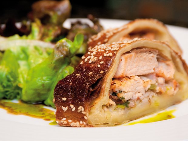 Herb salmon fillet in filo (strudel) pastry with sautéed rocket salad and Dijon mustard vinaigrette