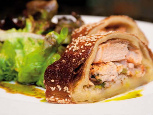 Herb salmon fillet in filo (strudel) pastry with sautéed rocket salad and Dijon mustard vinaigrette