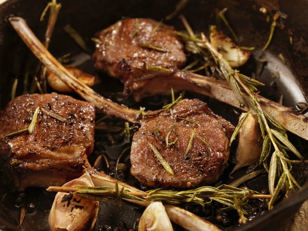 Rack of lamb with herb crust on zucchini vegetables with polenta