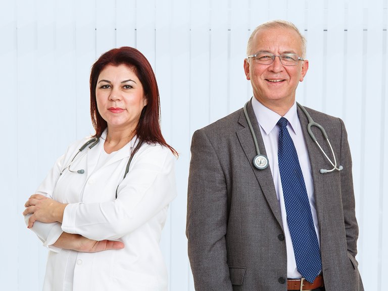 Female and male physician with stethoscopes