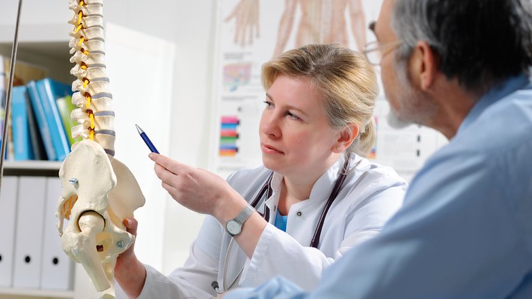 Physician explaining patient possible metabolic bone disease complications due to CKD