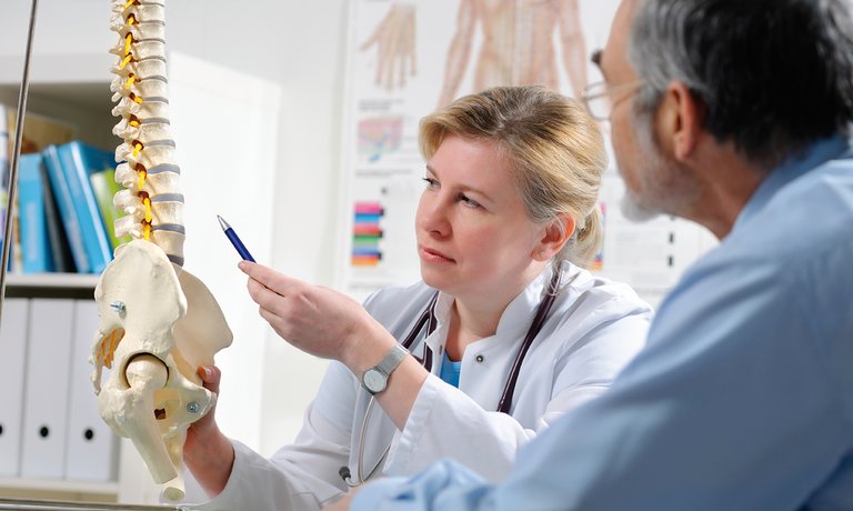 Physician explaining patient possible metabolic bone disease complications due to CKD