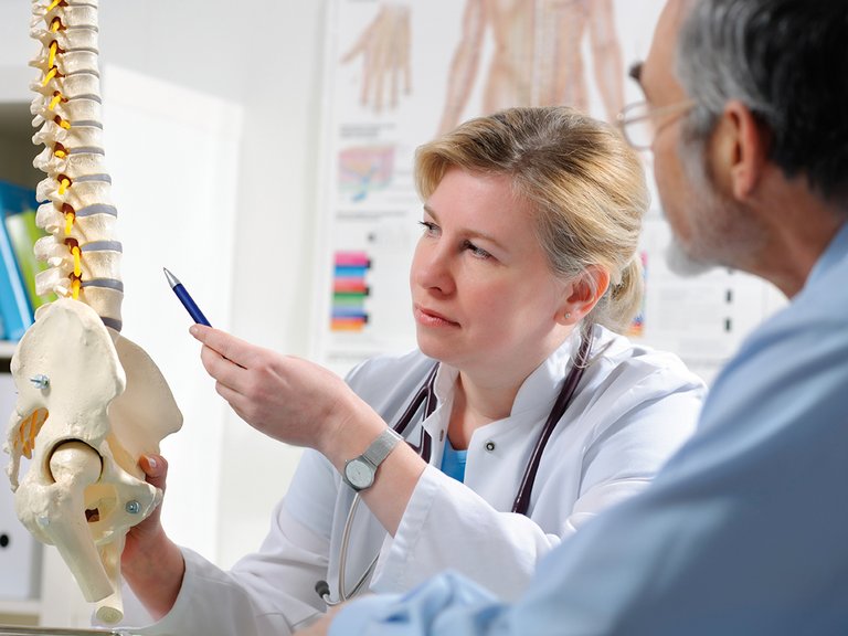 Physician explaining patient possible metabolic bone disease complications due to CKD