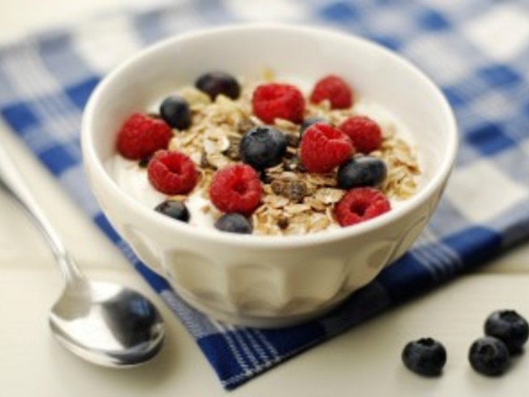 muesli Muesli bowl with oatflakes,raisins,fruits and yoghurt. Selective focus.